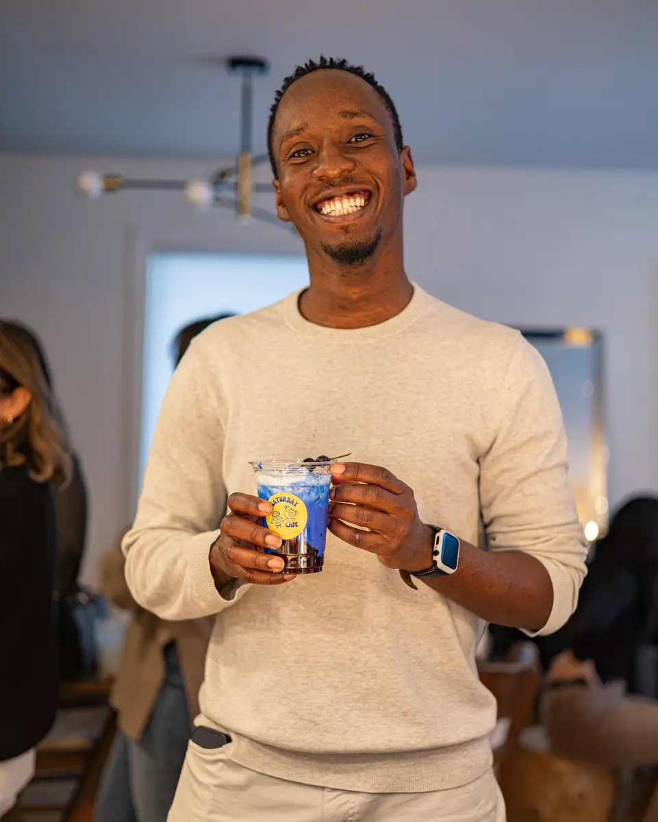 A guest smiling with his drink
