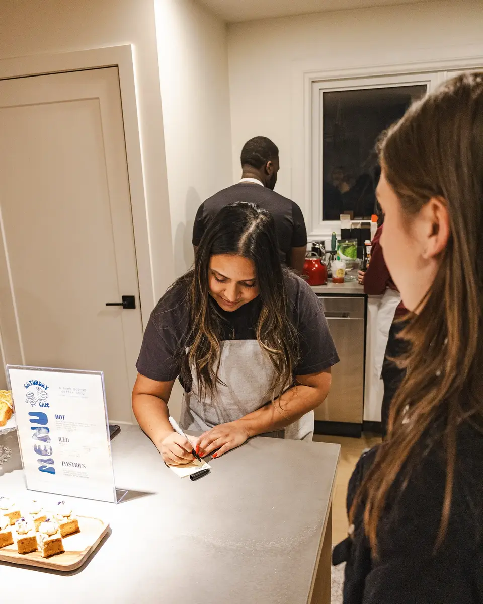 A barista serving a guest at the counter