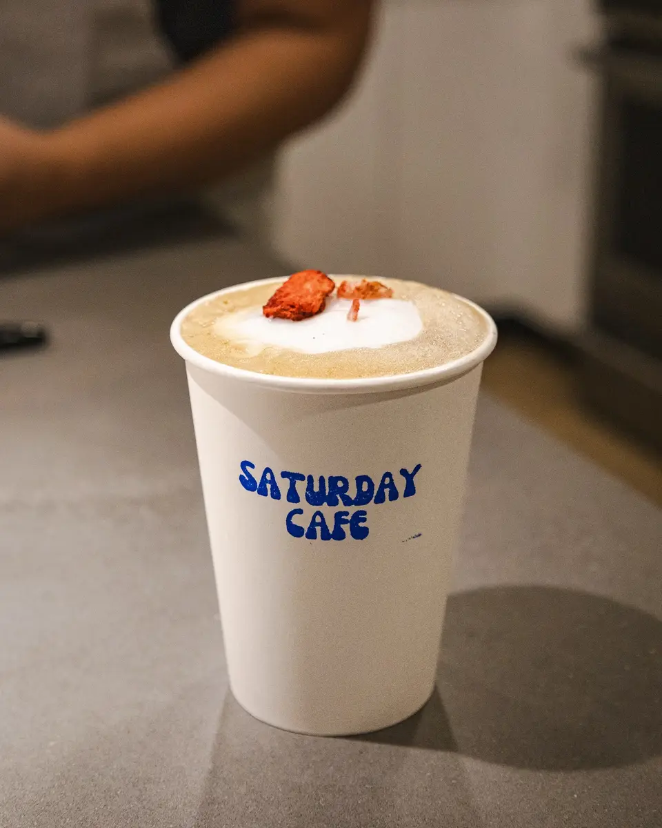 A Saturday Cafe branded mug